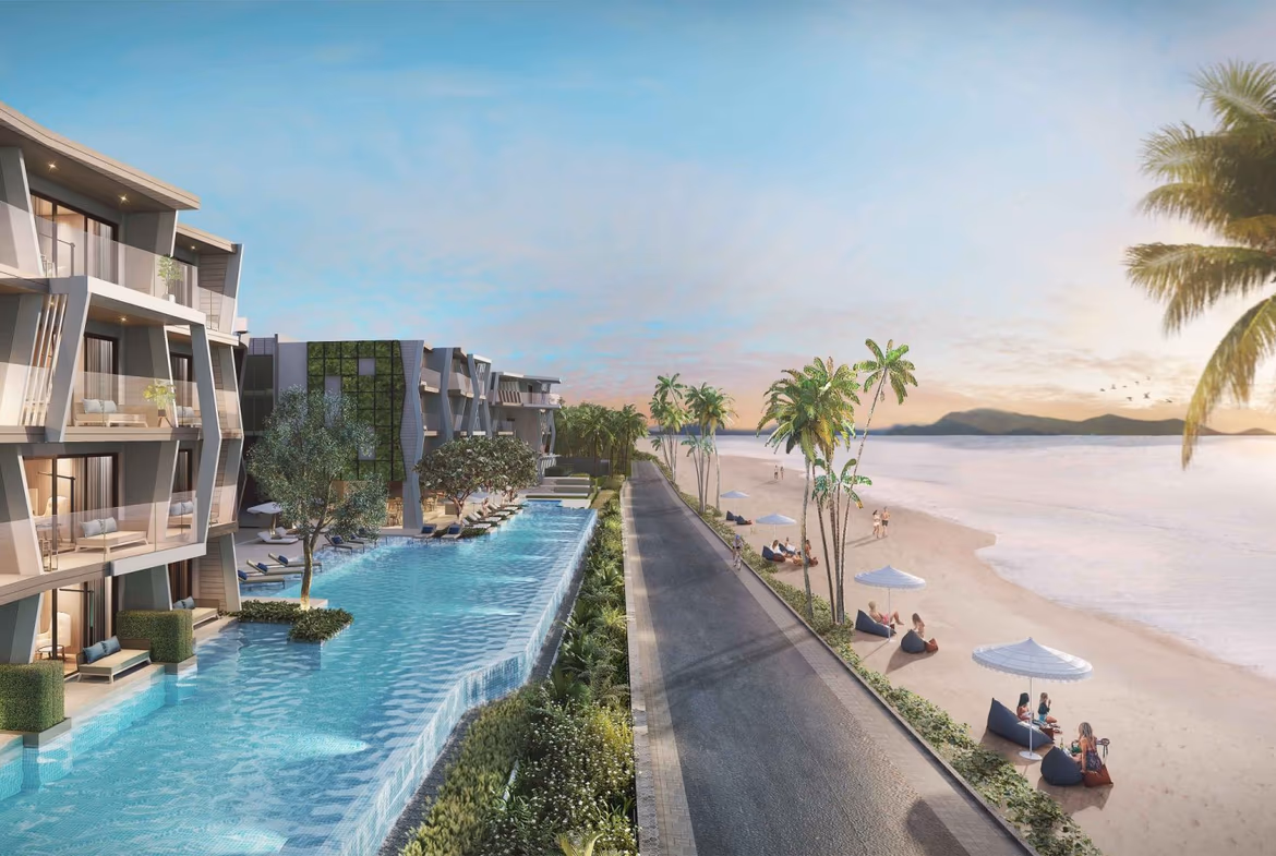 A modern, tastefully furnished living room with large windows overlooking a beach.