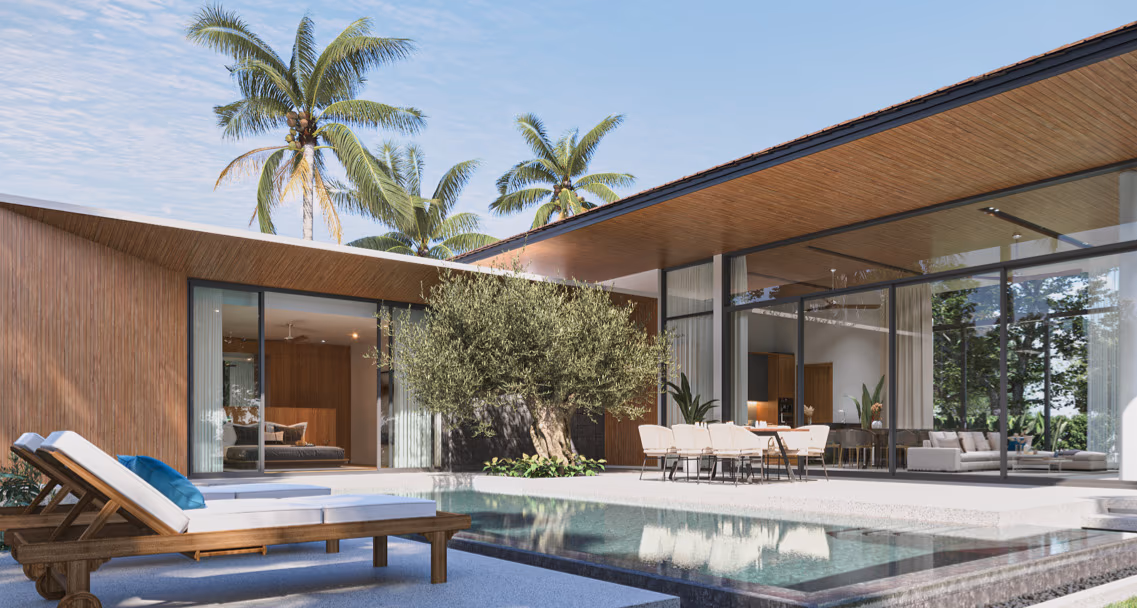A spacious, modern living room with large windows overlooking a tropical landscape.