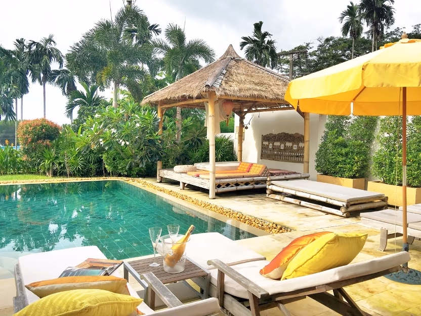 A three-bedroom villa in Cape Yamu features a private pool, visible in this photo. The modern architectural style of the villa is highlighted against the natural surroundings.