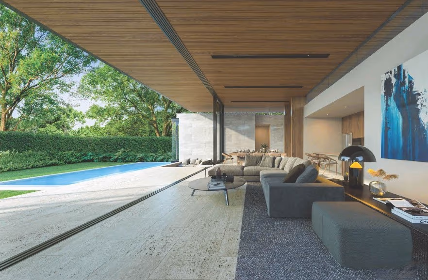 A modern bathroom with a spacious shower and a large window offering a glimpse of the surrounding greenery.