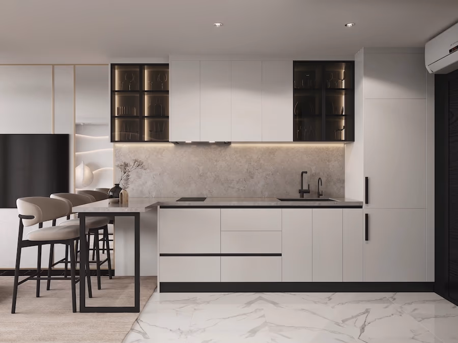 A modern kitchen with light wood cabinetry and an island overlooks an outdoor dining area and private pool.