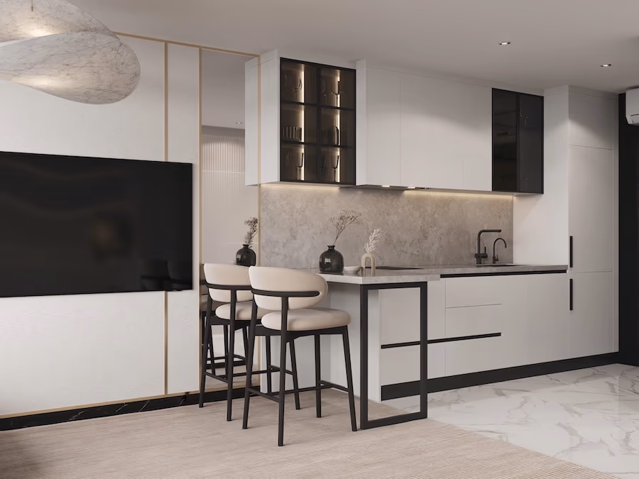 A modern kitchen with light wood cabinets, dark countertops, and stainless steel appliances.