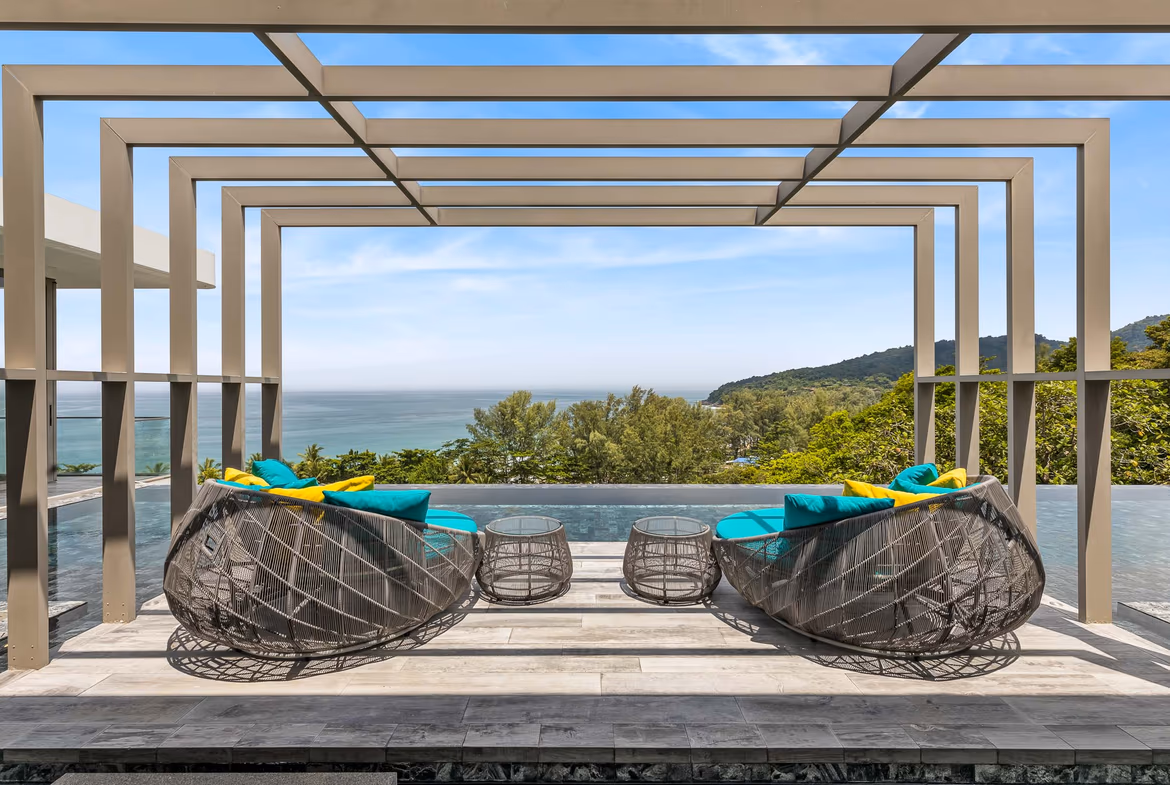 A bright, spacious living room with modern furnishings and a panoramic ocean view.