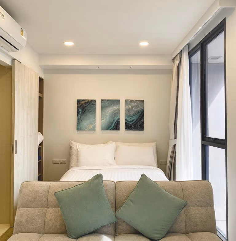 A bedroom with a bed and a view of a golf course.