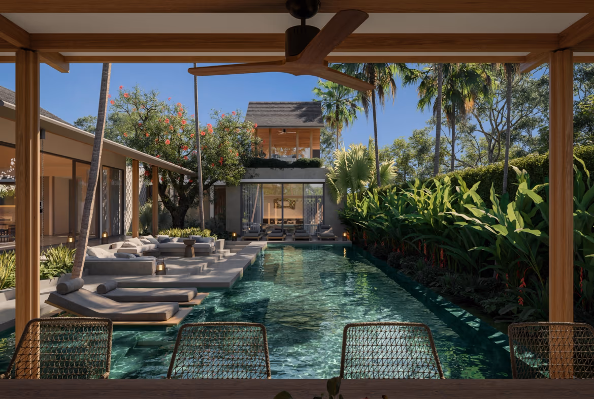 The spacious open-plan living area features comfortable seating and a dining table, overlooking the outdoor patio and swimming pool.