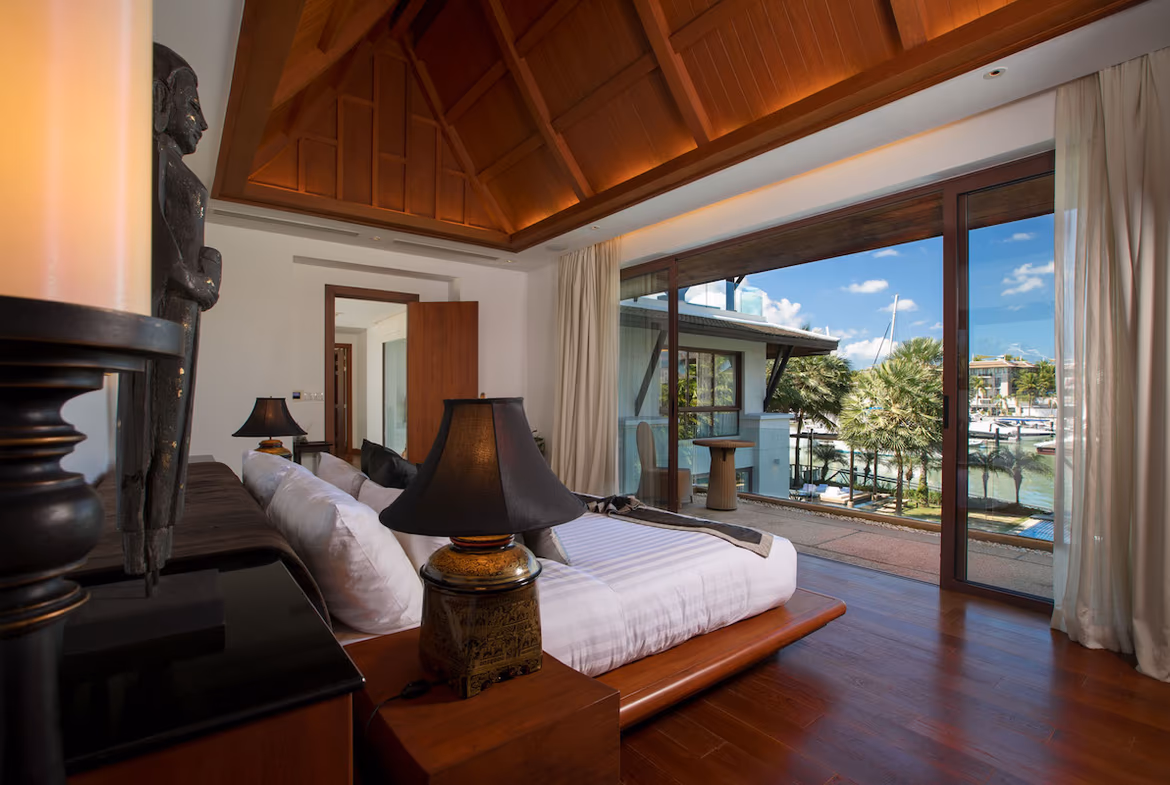 A spacious living room with modern furnishings and a view of the ocean.