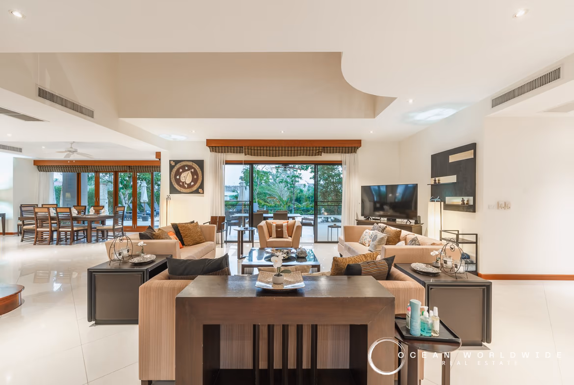 A large, elegant primary bathroom with a spacious walk-in shower and a freestanding bathtub.