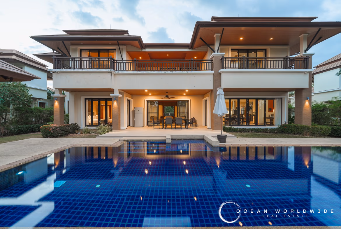 Exterior of a 5-bedroom villa in Laguna. A large private pool is visible in front of the house.