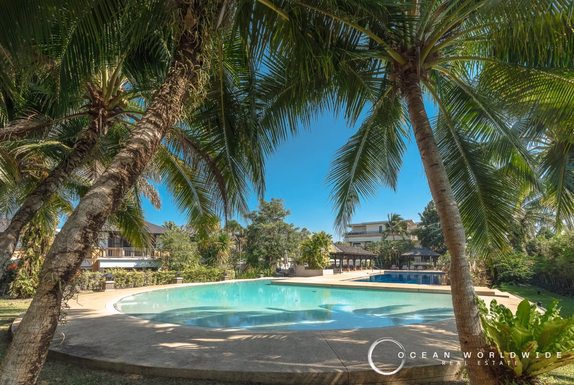 A three-bedroom apartment in Layan, part of a gated community, with multiple balconies overlooking the complex.