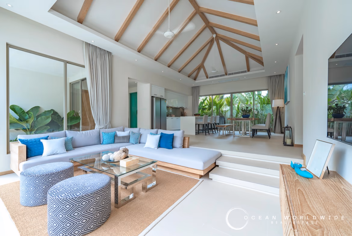 A spacious living room with modern furnishings and large windows.