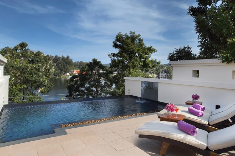 A luxurious private pool overlooking a serene lake.
