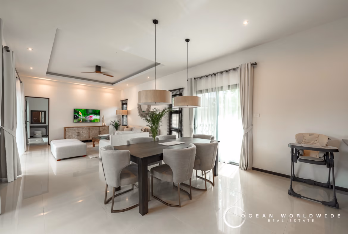 A spacious bedroom features a large bed, wooden floors, and sliding glass doors leading to a private balcony.
