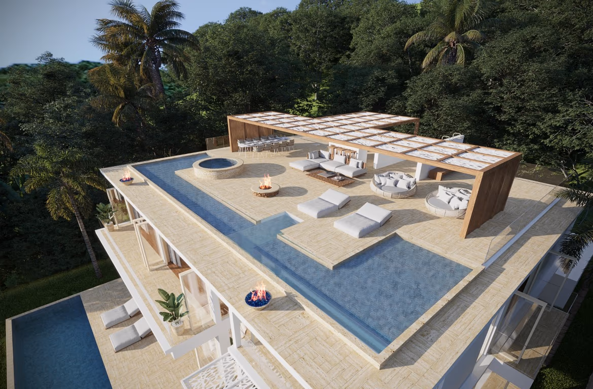 An infinity pool overlooks the ocean and surrounding tropical landscape.