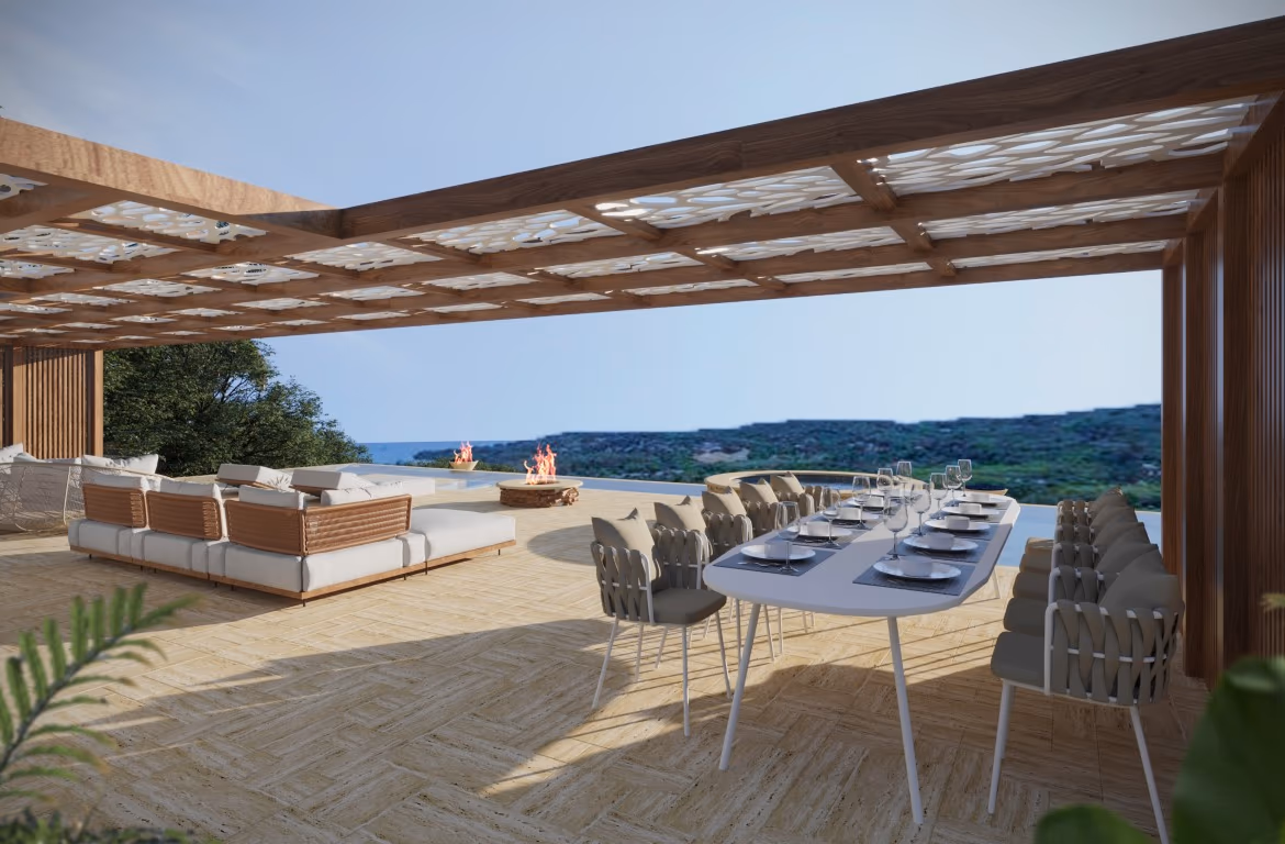 The photo shows a spacious, modern living room with large windows overlooking the sea.