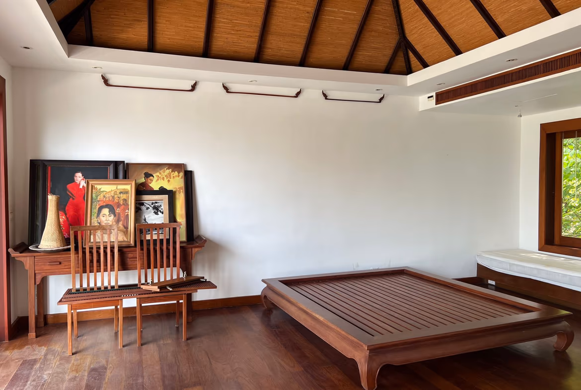 This photo likely features a bedroom with a large window and wood floors.