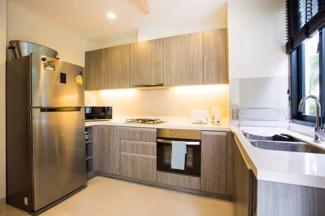 The photo shows a modern kitchen with a large island and ample cabinet space.