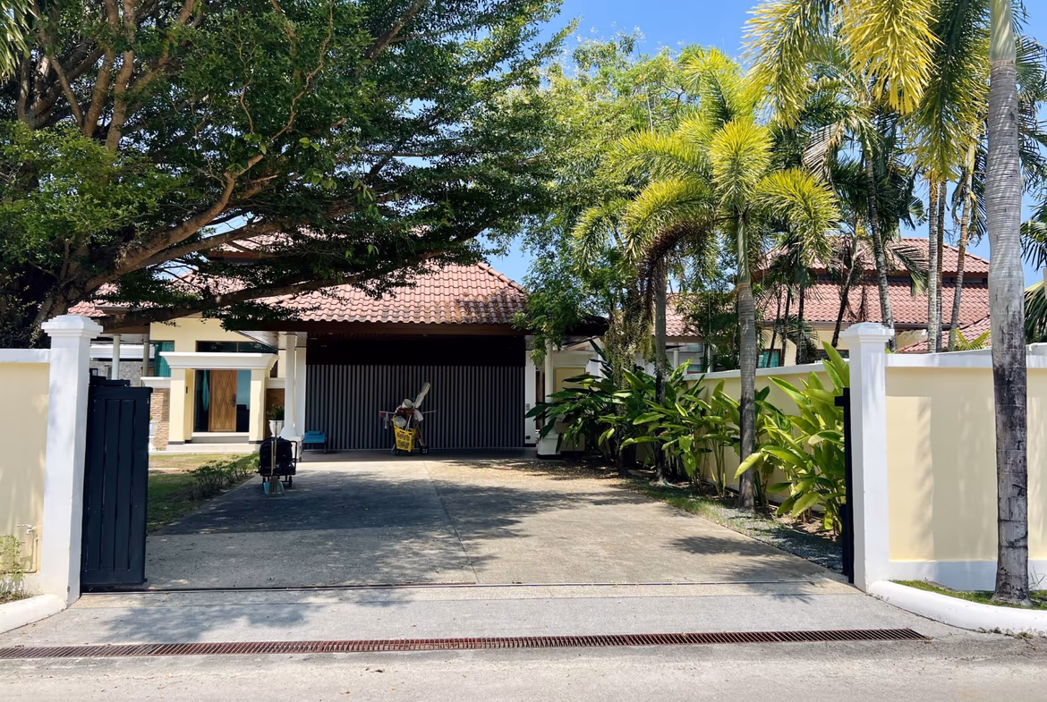 A spacious outdoor patio with lounge chairs and a swimming pool.