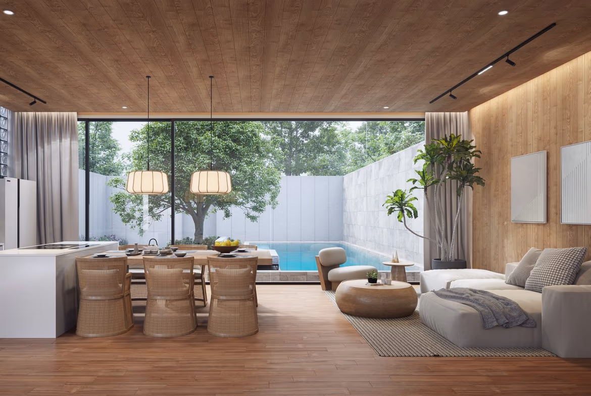 An outdoor swimming pool surrounded by lush tropical landscaping and a patio with lounge chairs.