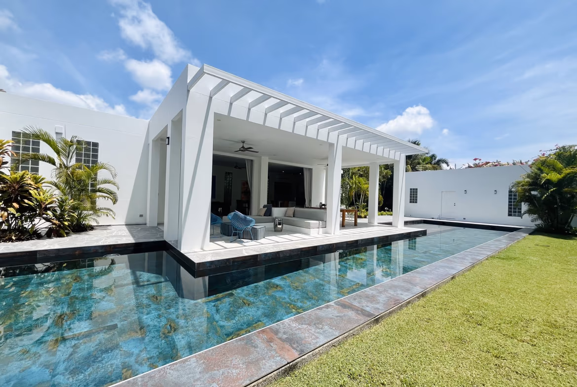 A modern, spacious living room with large windows and contemporary furniture.