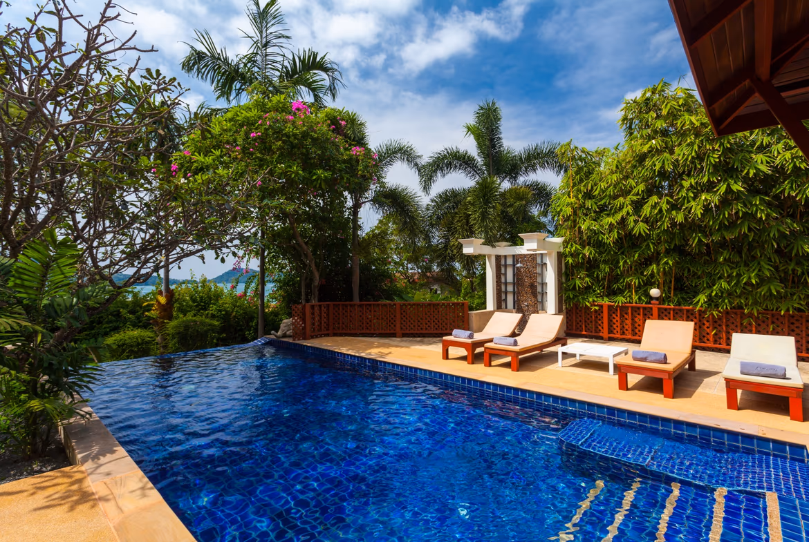 A three-bedroom villa in Patong with a private pool. The villa's modern exterior has a sea view.