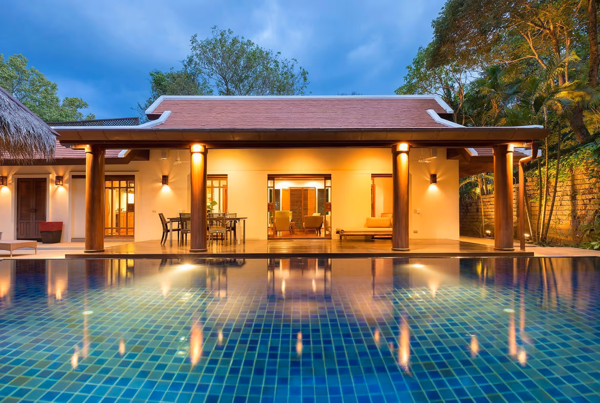 A spacious living room with natural light and a view of the pool.