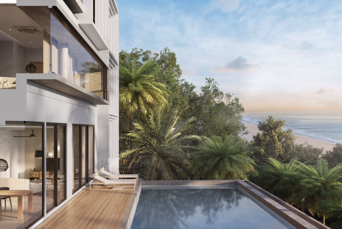 Two-bedroom villa in a gated community in Ao Yon. The home has a red tile roof and is surrounded by palm trees.