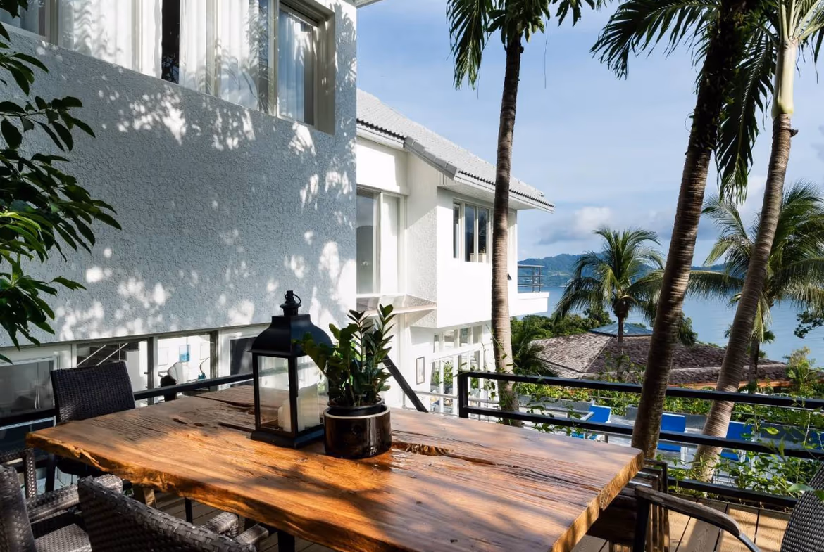 A spacious living area with modern décor and a large window offering ocean views.