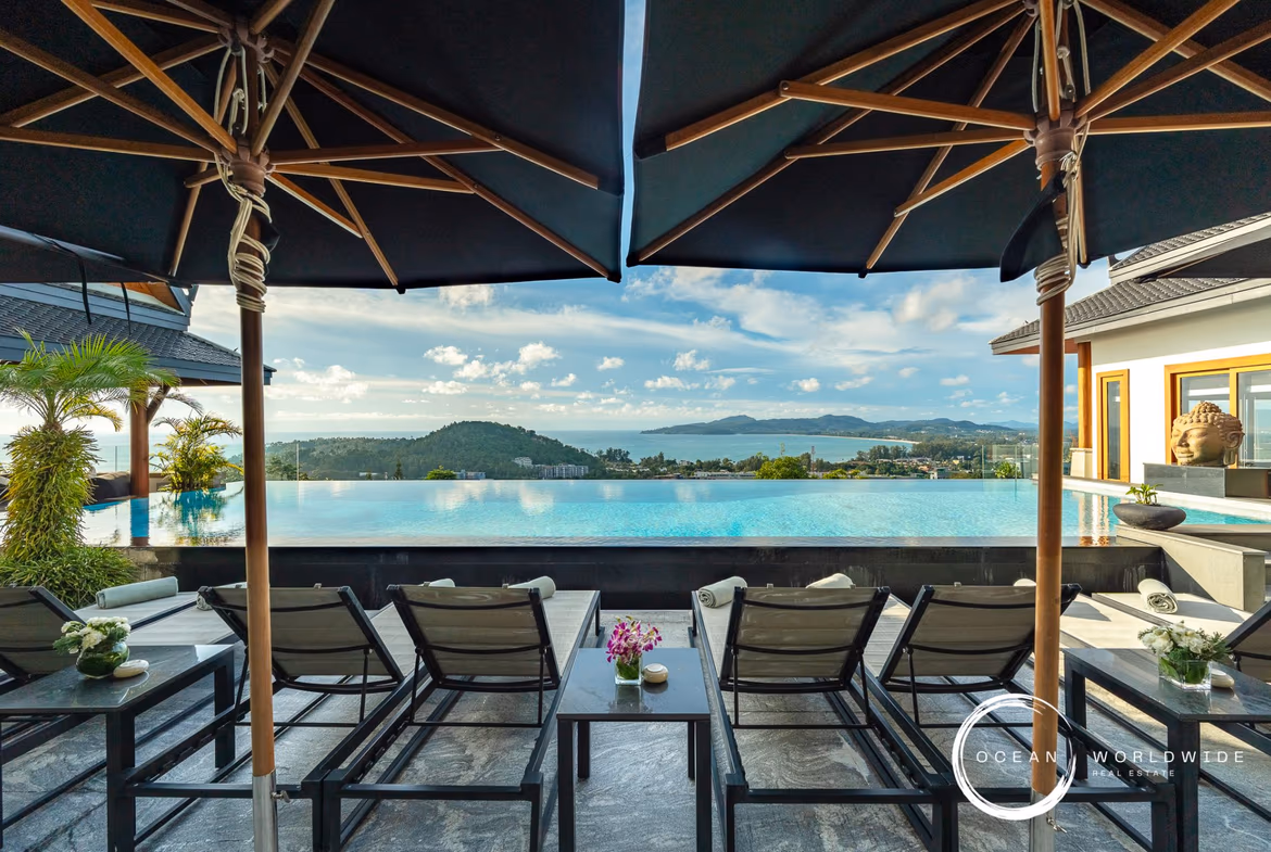 A large en suite bedroom with a private balcony overlooks the sea.