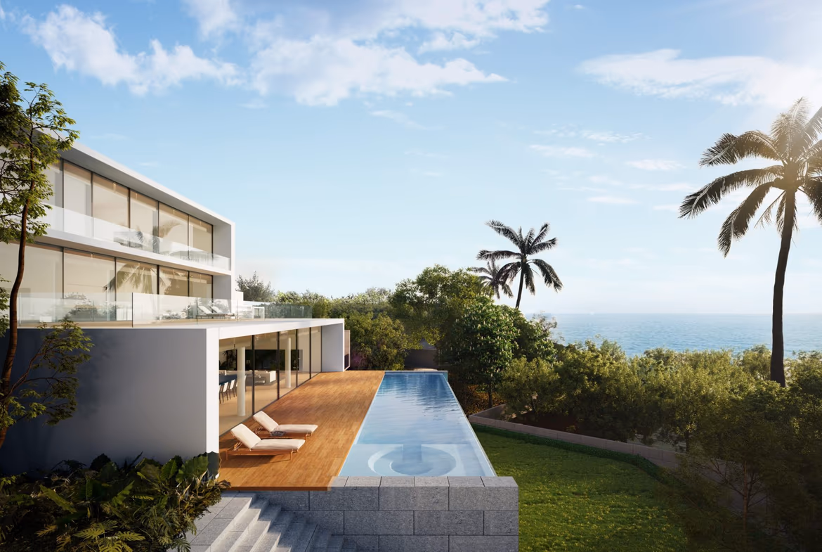 A modern bathroom with a white freestanding bathtub and a view of the sea.