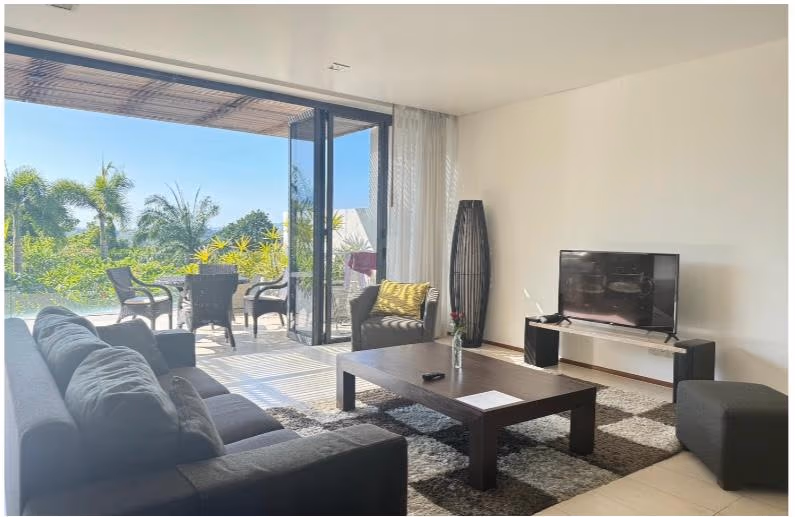 This photo likely shows a bedroom with a view of the ocean.