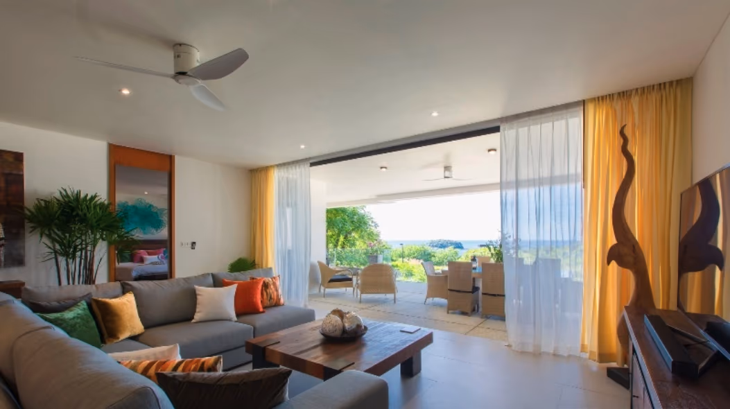 A bedroom with a large window likely overlooking the sea.