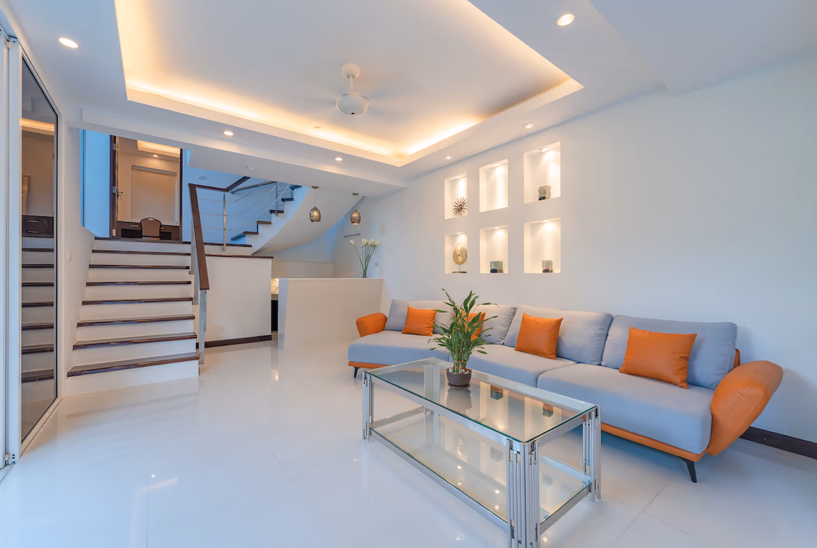 A modern kitchen with light wood cabinets and stainless steel appliances.
