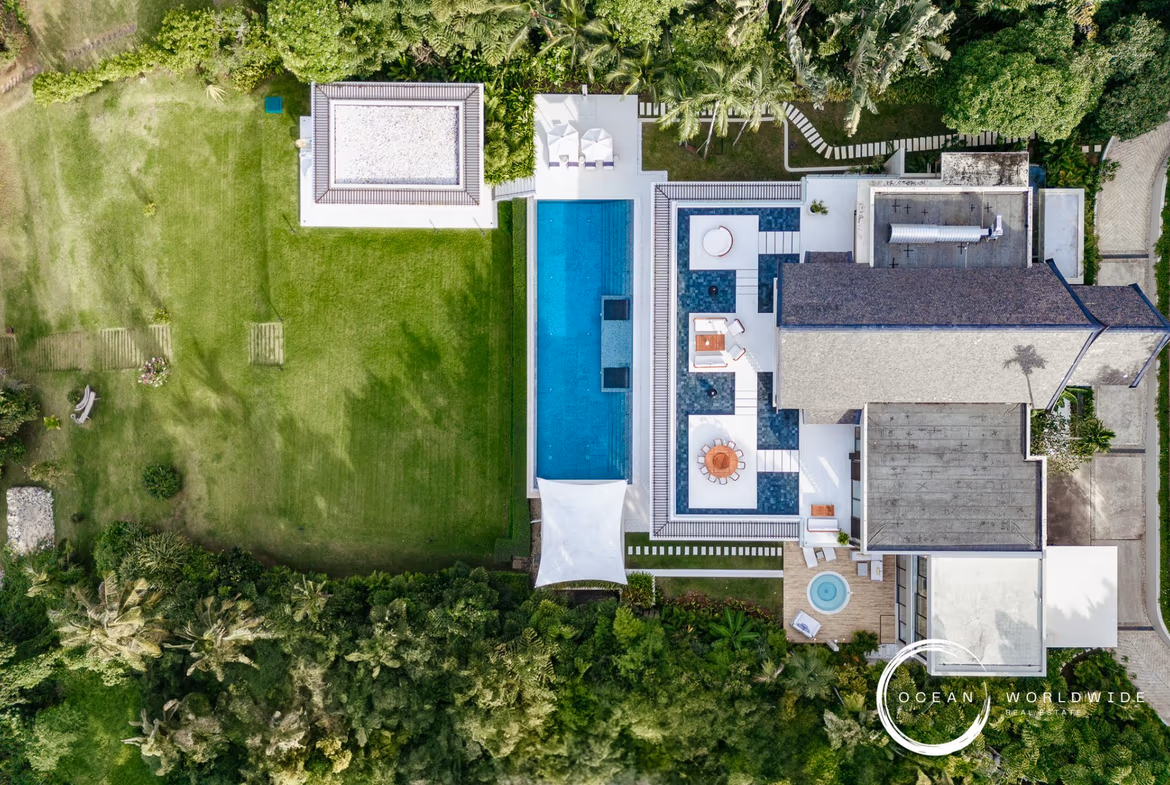 Exterior view of a five-bedroom villa in Cape Yamu, featuring a private swimming pool overlooking the ocean.
