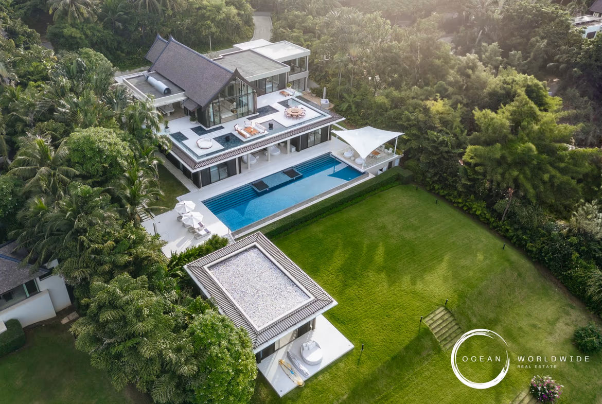 An infinity pool overlooks the ocean and a distant shoreline.