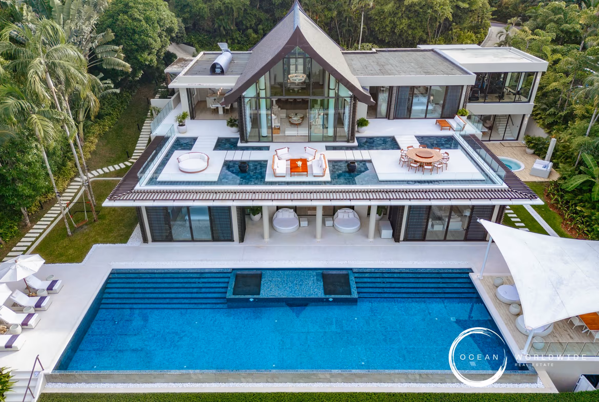 View of the sea from a large balcony, with a glimpse of an infinity pool.