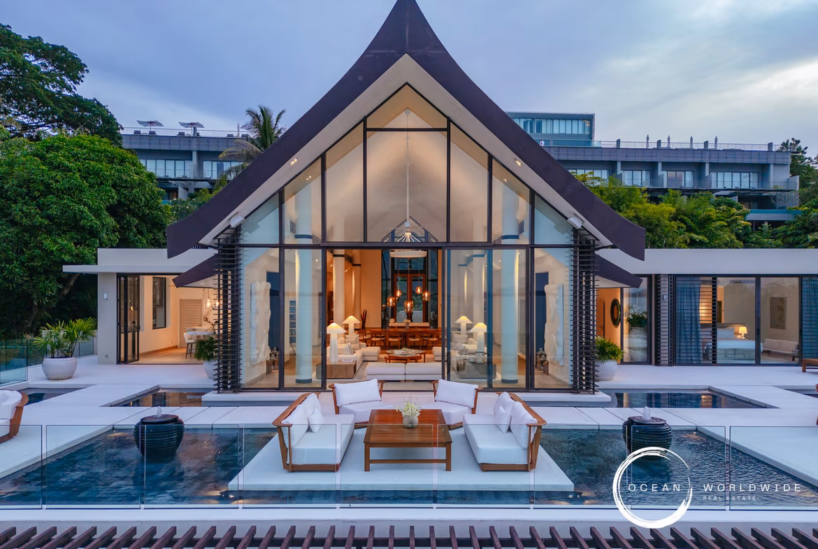 A large infinity pool overlooks the ocean and a distant shoreline.