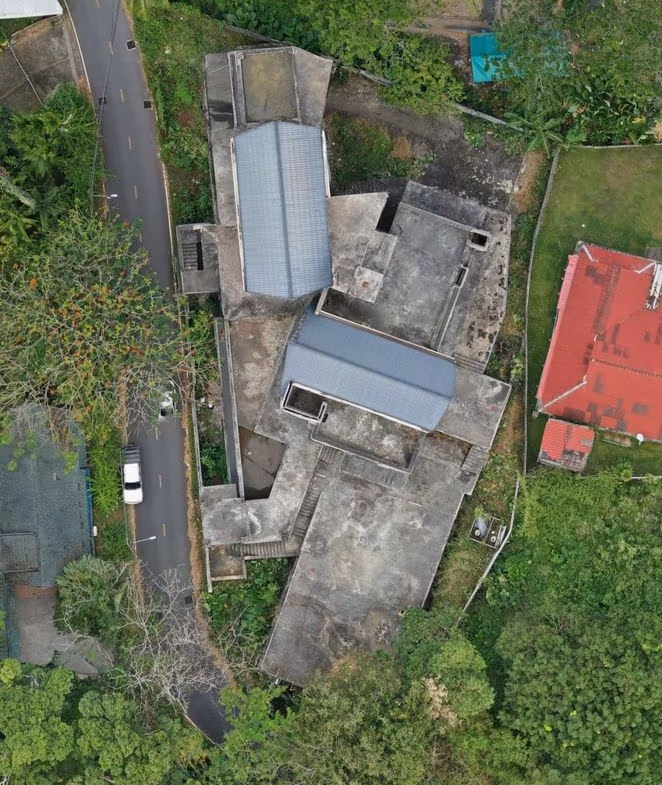A prime plot of land with a building is for sale near Surin Beach.