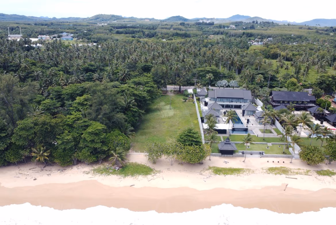 A view of a sandy beach and the ocean from a high vantage point.