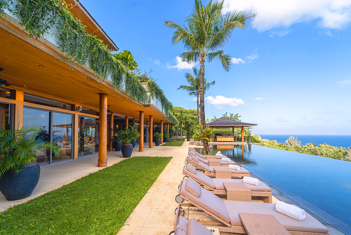 Seaside villa with a private pool and stunning sunset view.