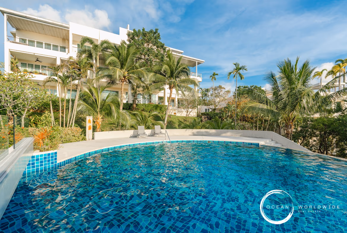 A spacious living area with modern décor and large windows overlooking the ocean.
