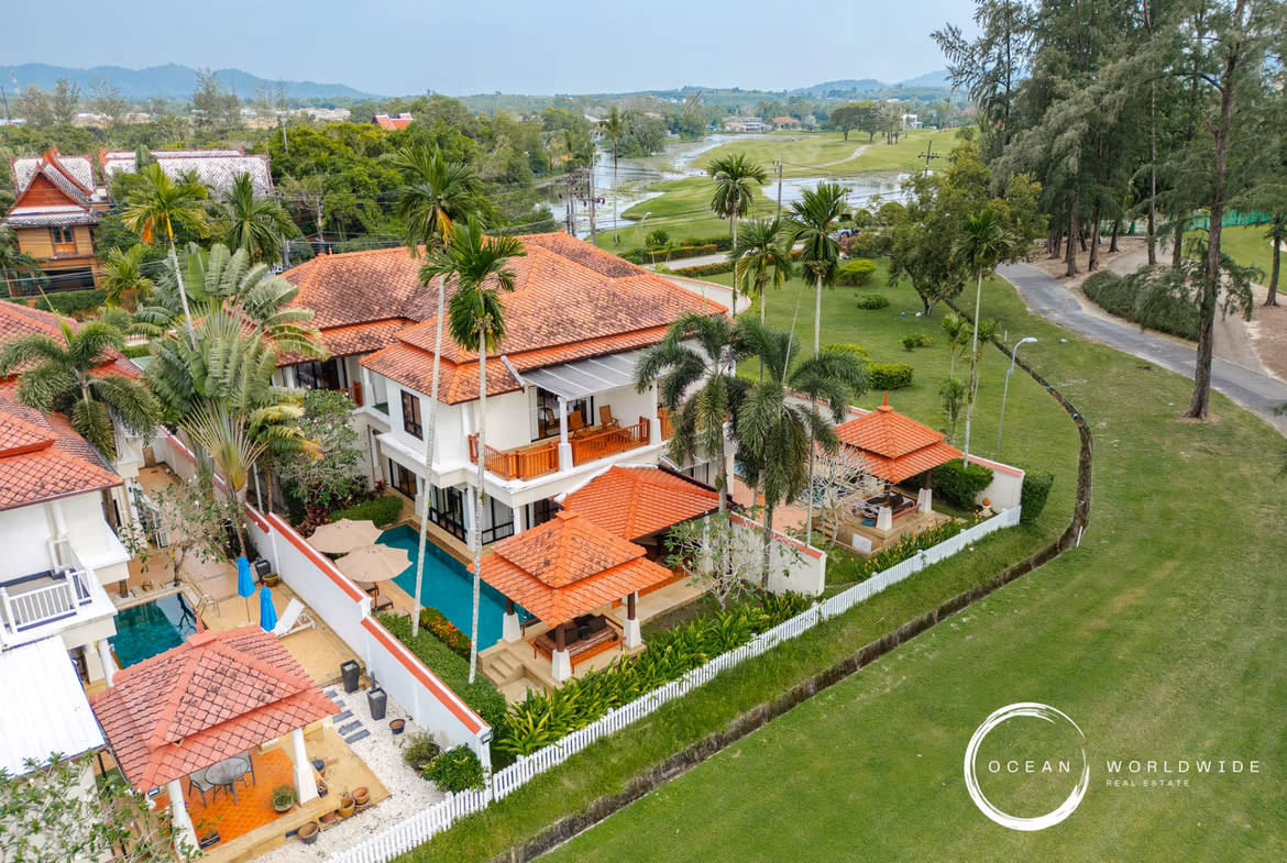 A four-bedroom villa in Layan features a private pool. The spacious, multi-story home is surrounded by lush tropical landscaping.
