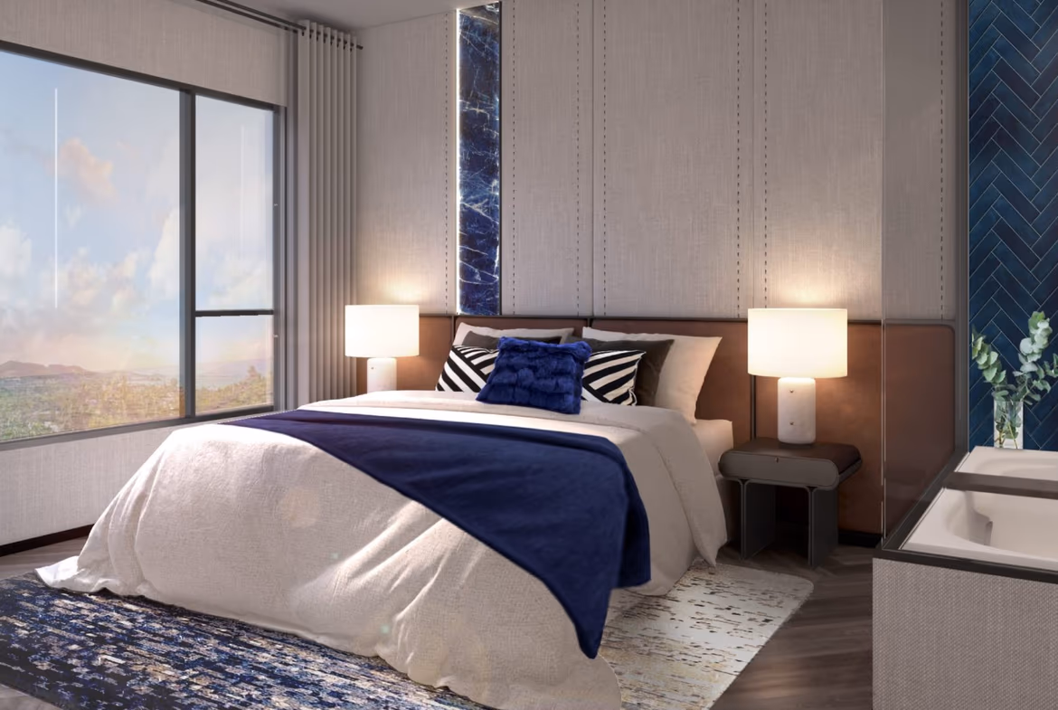 A spacious ocean-view living room with a large L-shaped sofa and a glass-enclosed balcony.