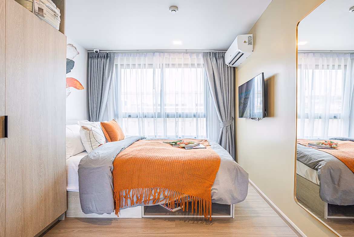 Exterior of a one-bedroom condominium in a Phuket gated community. The modern building features a clean, white facade.