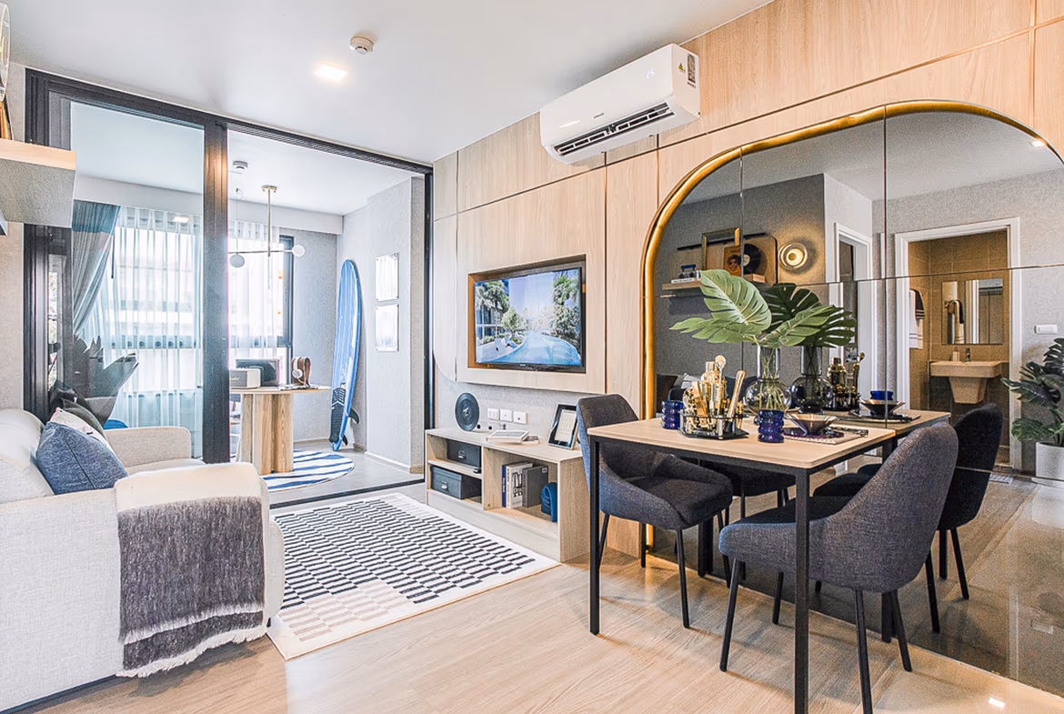 A modern bathroom with a glass-enclosed shower and a large window overlooking lush greenery.