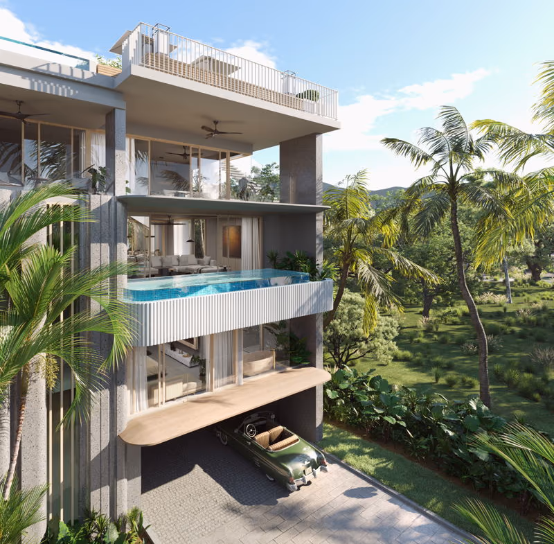 This is an exterior photo of a villa within a gated community in Phuket. The multi-story residence has balconies and a private pool area.