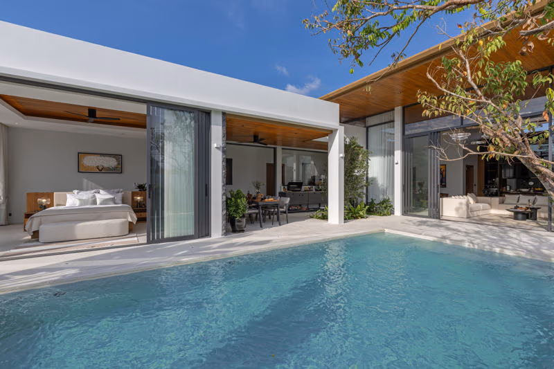 Three-bedroom villa in Phuket with a private pool. The exterior photo shows the villa's white facade under a clear sky.