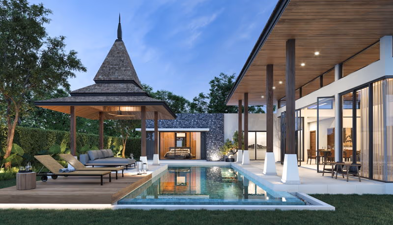 This three-bedroom Balinese-style villa in Phuket features a private pool. The exterior shot showcases the villa's elegant design and the inviting pool area.