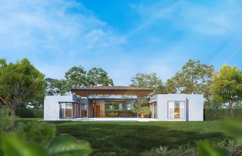 An exterior photo showing a modern villa with a rectangular swimming pool, surrounded by palm trees and lush vegetation.
