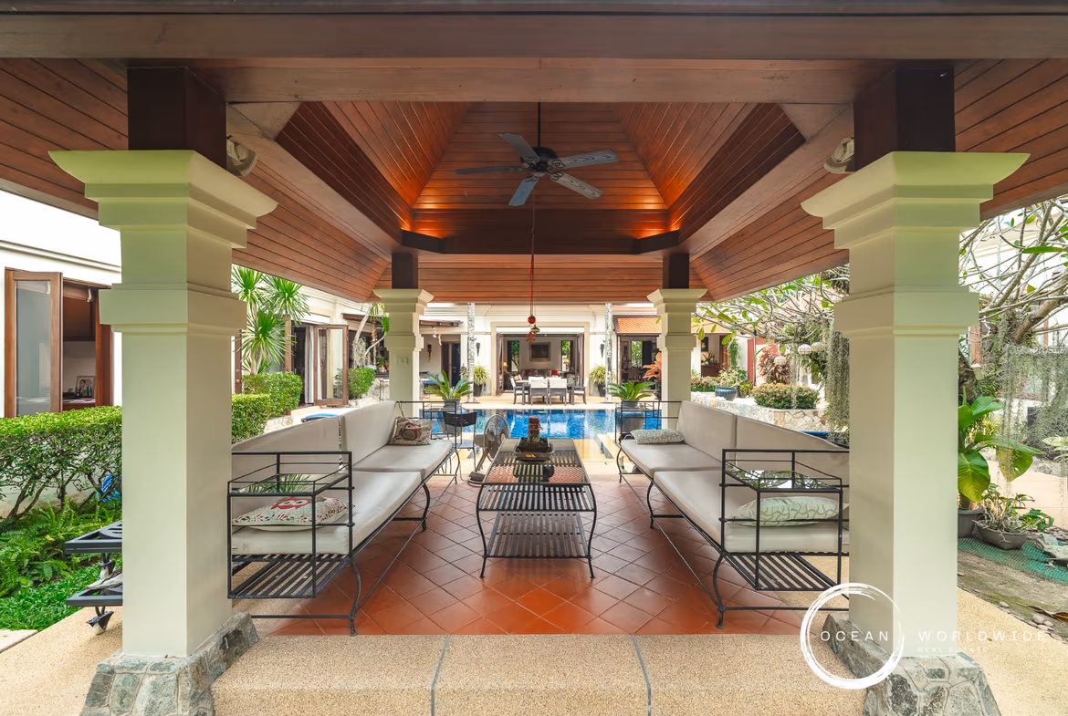 A spacious bedroom with a king-sized bed and direct access to a private balcony overlooking the ocean.