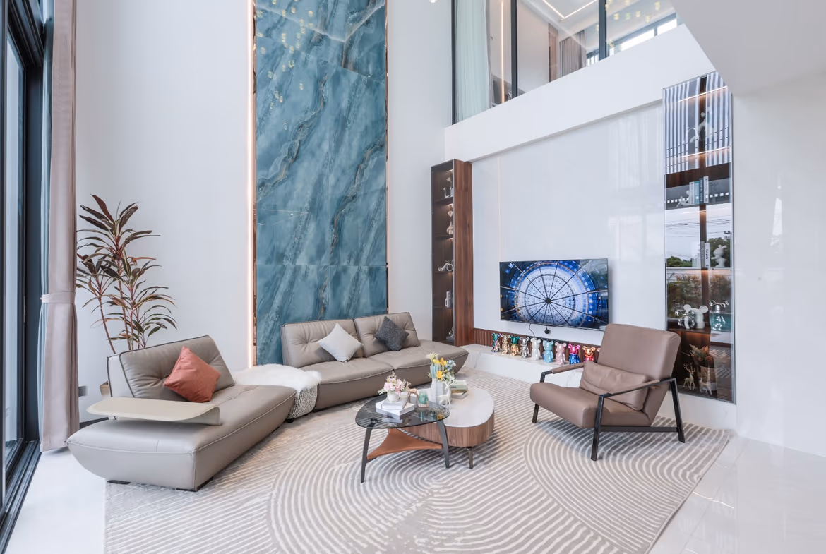 A modern, nature-inspired villa featuring four bedrooms and a view of lush greenery.